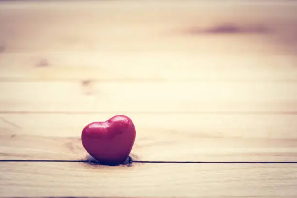 Photo of Red little heart on wood. Vintage concept of love, Valentine's Day