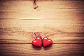 A couple of red little hearts on wood. Vintage concept of love, Valentine's Day