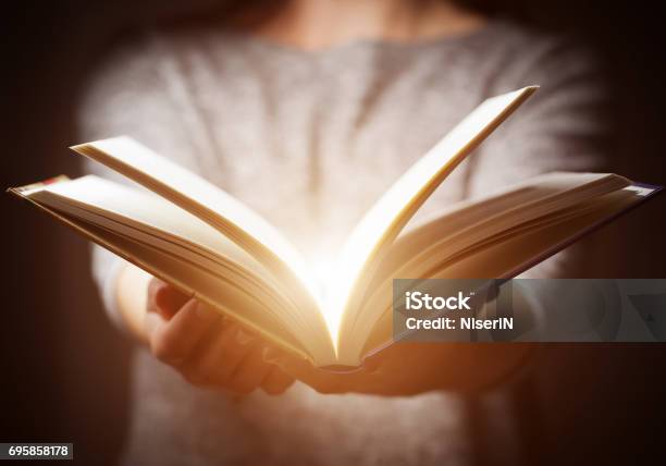 Light Coming From Book In Woman39s Hands In Gesture Of Giving Stock Photo - Download Image Now