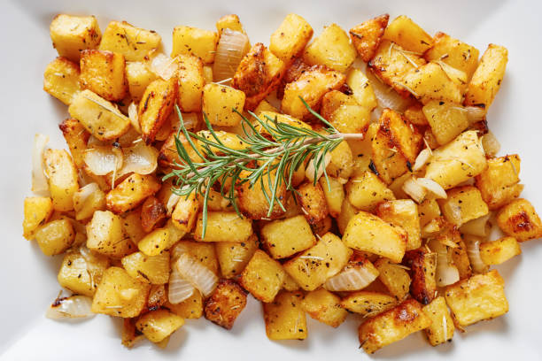 istock Close-up of Roasted potatoes on white square plate 695859000