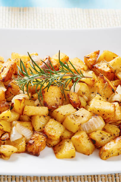 istock Close-up of Roasted potatoes on white square plate 695859006
