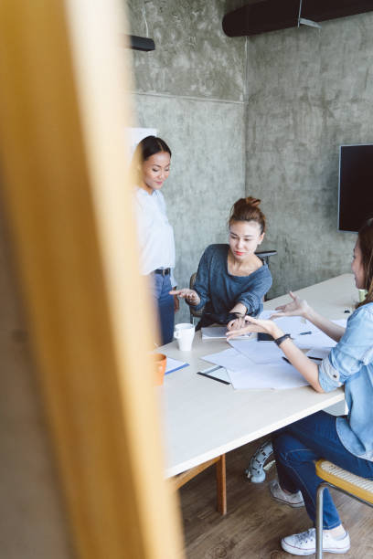 istock Group of colleagues having a brainstorming session at work 695859978