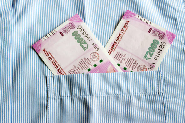 Indian currency in shirt's pocket.