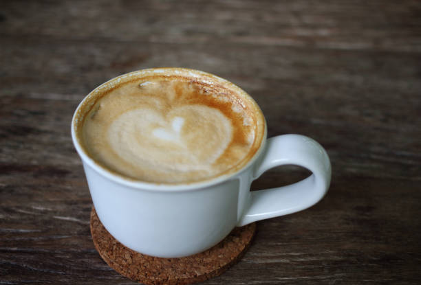 istock coffee with heart in a white cup on wooden background 695863626