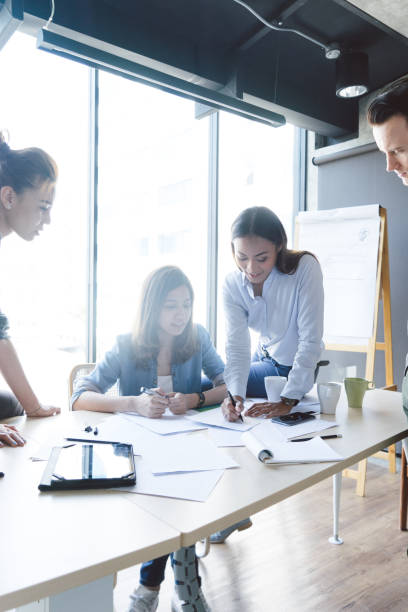 istock Group of colleagues having a brainstorming session at work 695866278