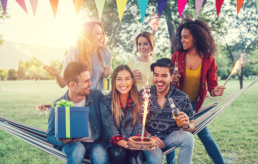 Group of friends enjoying a birthday party among nature