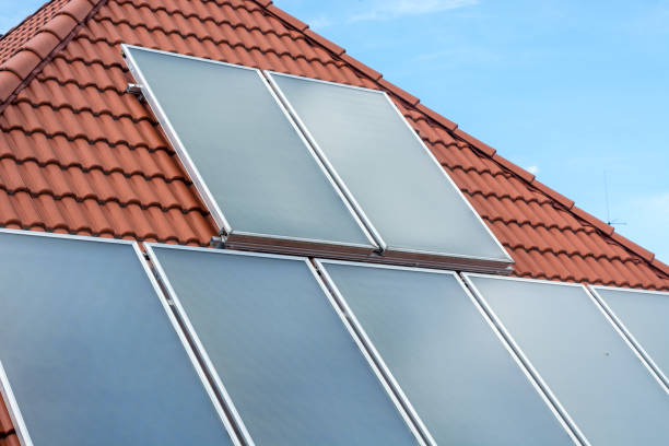 istock Solar panels installed on a roof with the sky 695869804