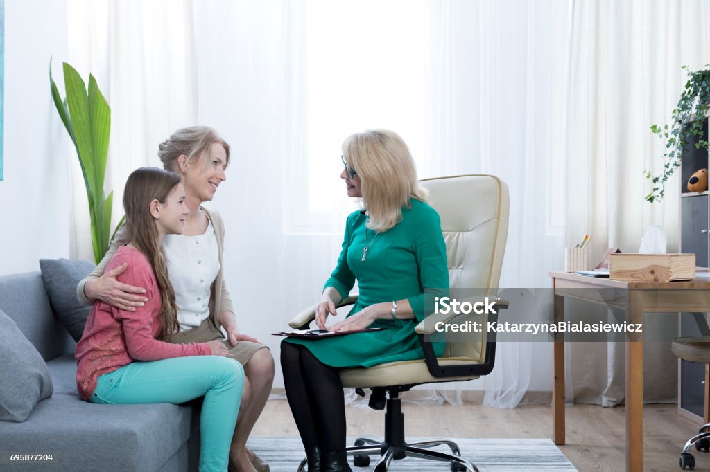 Thankful for help Loving mother and daughter thankful for therapist's help Mental Health Professional Stock Photo