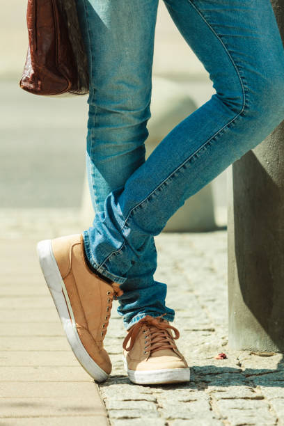 istock Man standing on street, jeans outfit no face 695877614