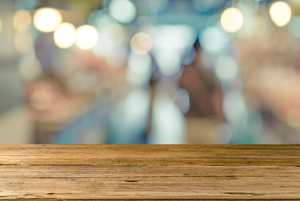 istock Empty wooden desk on market background 695879938