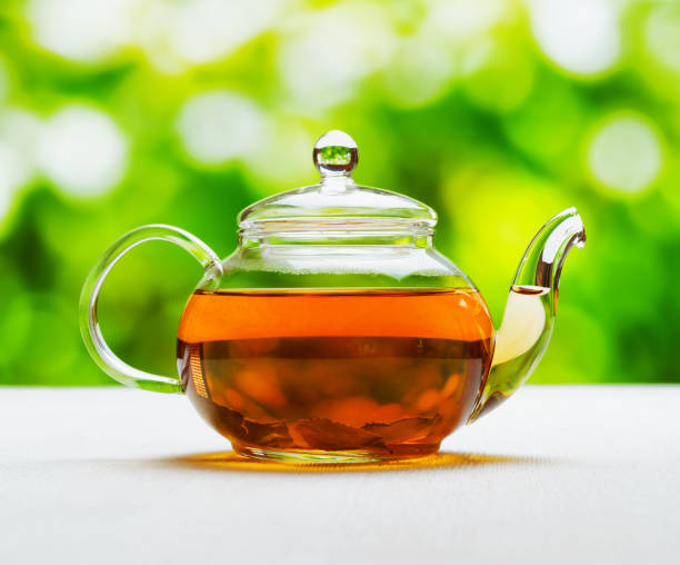 istock Teapot of fresh tea on natural background 695880968