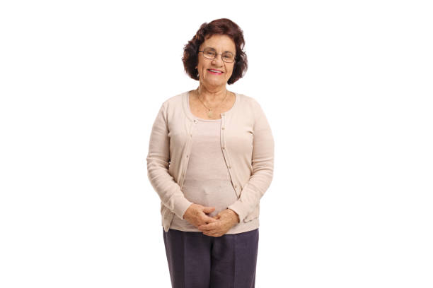 Senior lady looking at the camera and smiling Senior lady looking at the camera and smiling isolated on white background one senior woman only stock pictures, royalty-free photos & images