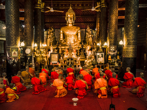 Buddhist monks celebrate Vesak, also called Vixakha Bouxa festival, in Wat Mai Suwannaphumaham temple Luang Prabang Laos. This festivity commemorates the birth, enlightenment and death of Gautama Buddha.