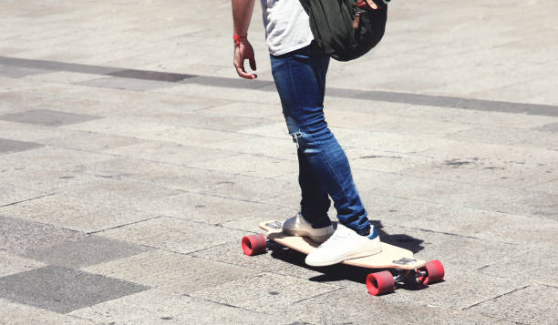 istock Man on a skateboard longboard closeup in the city 695890562