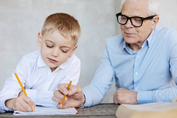 istock Educated mature gentleman correcting mistakes 695893510