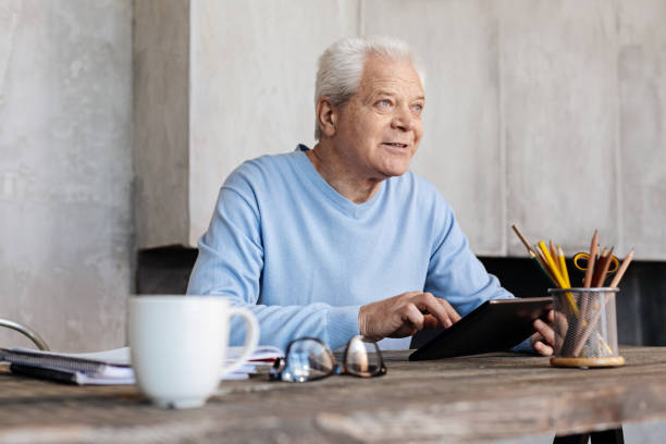 istock Good looking elderly man enjoying a productive morning 695897152
