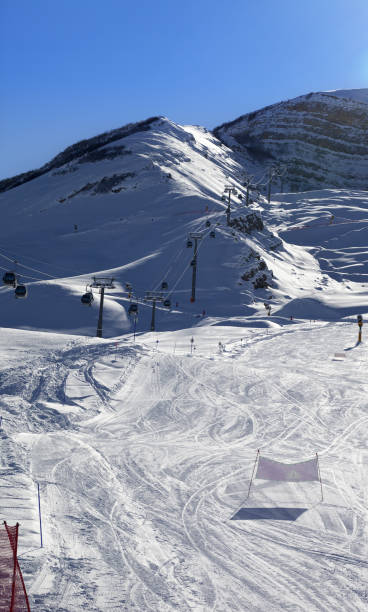 istock Ski slope and gondola lift at sun winter evening 695897730