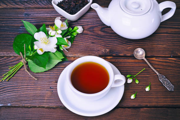 istock Black tea and a bouquet of blossoming jasmine 695901104