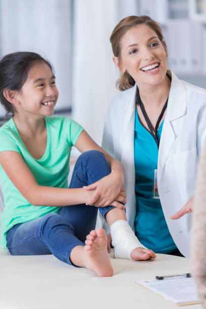 istock Cheerful ER doctor talks with patient's mom 695908338