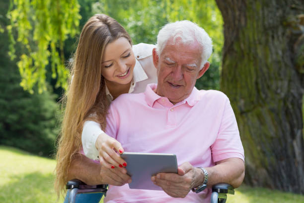 Girl helping senior with tablet Young girl helping the senior man using the tablet united states senate committee on health education labor and pensions stock pictures, royalty-free photos & images