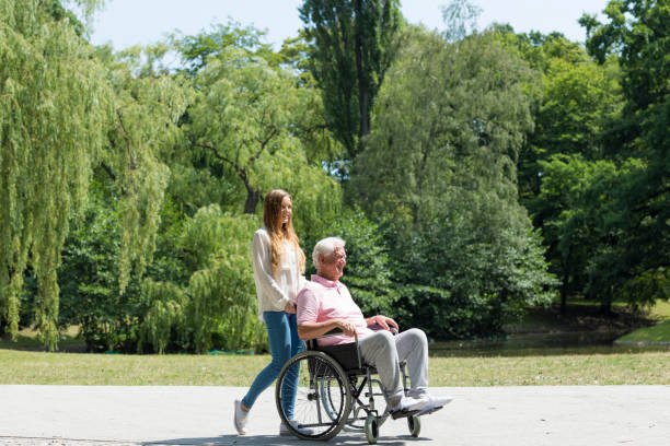 istock Young girl with elder man in the park 695914820