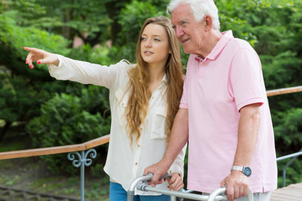 Girl giving directions to the elder man Long-haired girl giving directions to the elder man using a walking frame united states senate committee on health education labor and pensions stock pictures, royalty-free photos & images