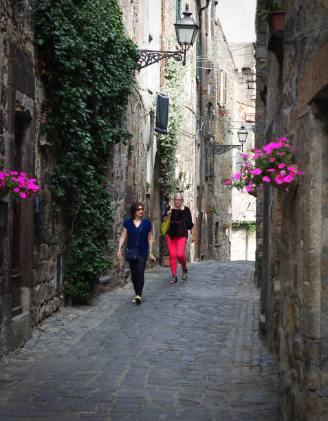 istock Bolsena, Tuscany, Italy: Active Seniors Explore Narrow Medieval Lane 695915708