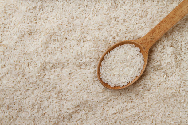 istock Raw rice in wooden spoon 695917484