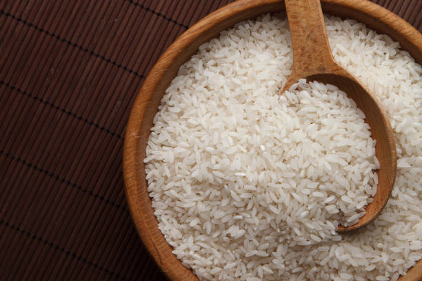 istock Raw rice in wooden bowl 695917906