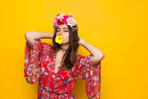 istock Woman with flower in mouth 695921092