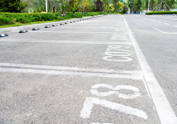 istock Empty car parking lot with white lines 695921220