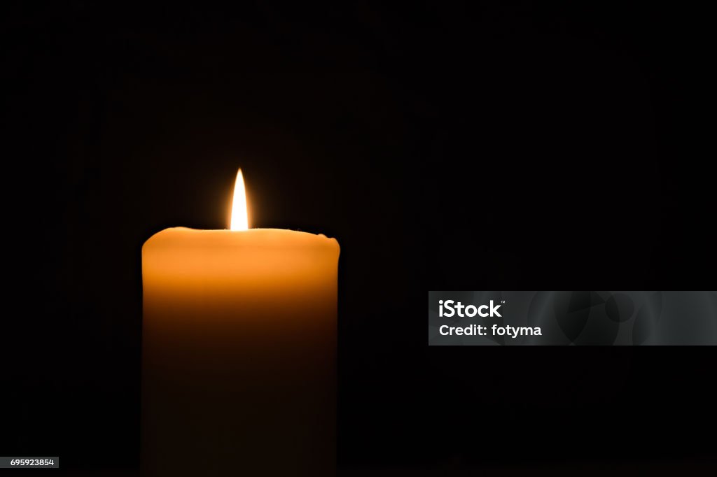 candle light on the black background Single candle burning burning brightly in the black background. Candle Stock Photo