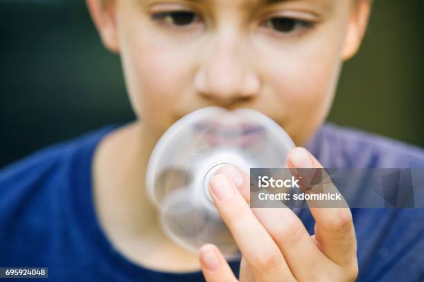 Boy Holding Spinner Stock Photo - Download Image Now - Attention Deficit Hyperactivity Disorder, Child, Fidget Spinner