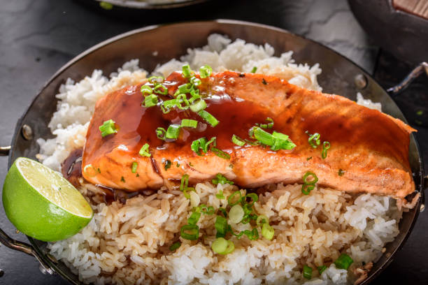 istock Pan Fried Salmon Steak with Teriyaki Sauce over Rice 695928096