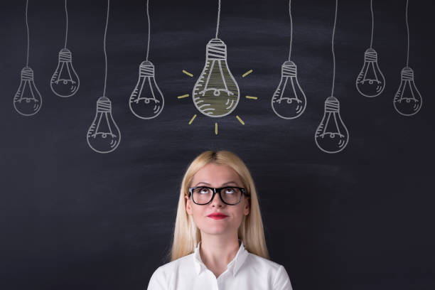 istock Business woman and big idea bulbs 695932154