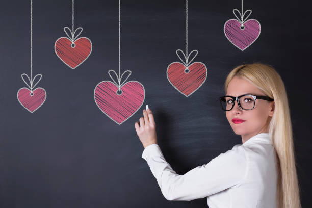 istock Hanging hearts on the blackboard 695936692