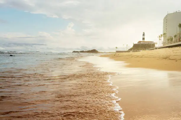 Photo of Barra beach during sunset with lighthouse background