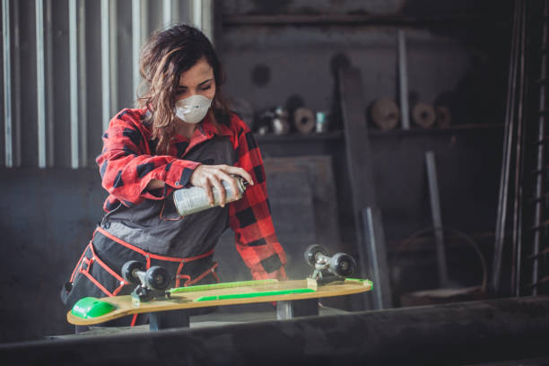 istock Woman repairing skateboard in workshop 695939788