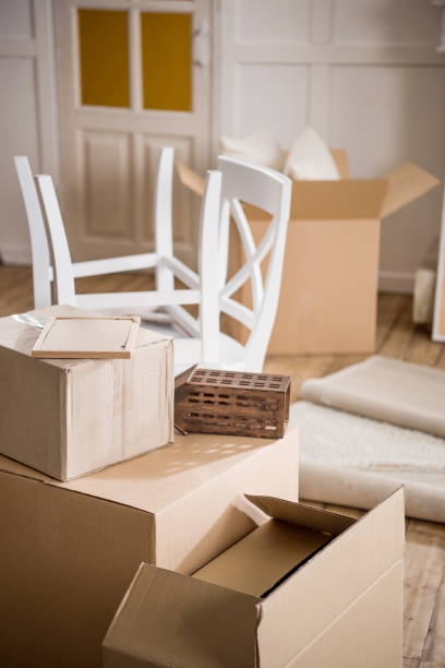 istock Cardboard boxes and furniture in empty room, relocation concept 695940484