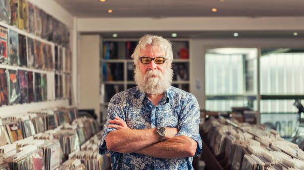 Record store owner portrait Horizontal color portrait of a senior record store owner in his shop. dutch culture photos stock pictures, royalty-free photos & images