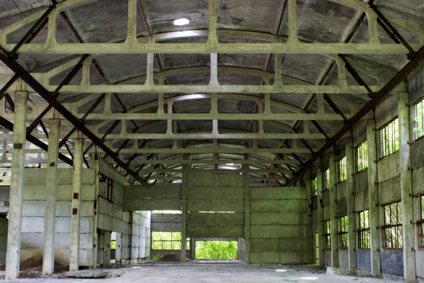 istock Abandoned unworthy hangar inside, among the day 695943054