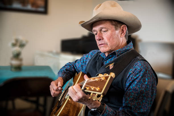 istock Western cowboy playing guitar 695944320