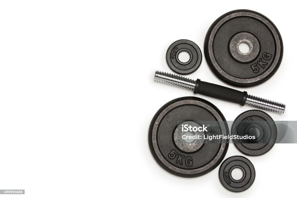 Top view of heavy weight plates with iron bar isolated on white Weights Stock Photo