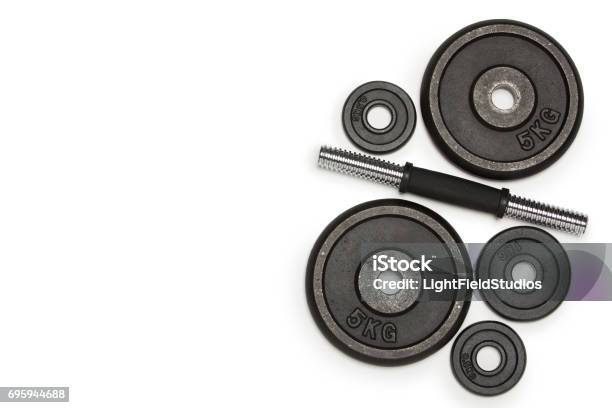 Top View Of Heavy Weight Plates With Iron Bar Isolated On White Stock Photo - Download Image Now