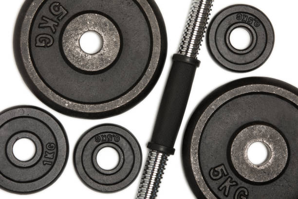istock Close-up view of different weight plates for weight training isolated on white 695946992