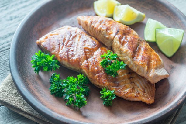 istock Roasted salmon steak with fresh parsley 695947546