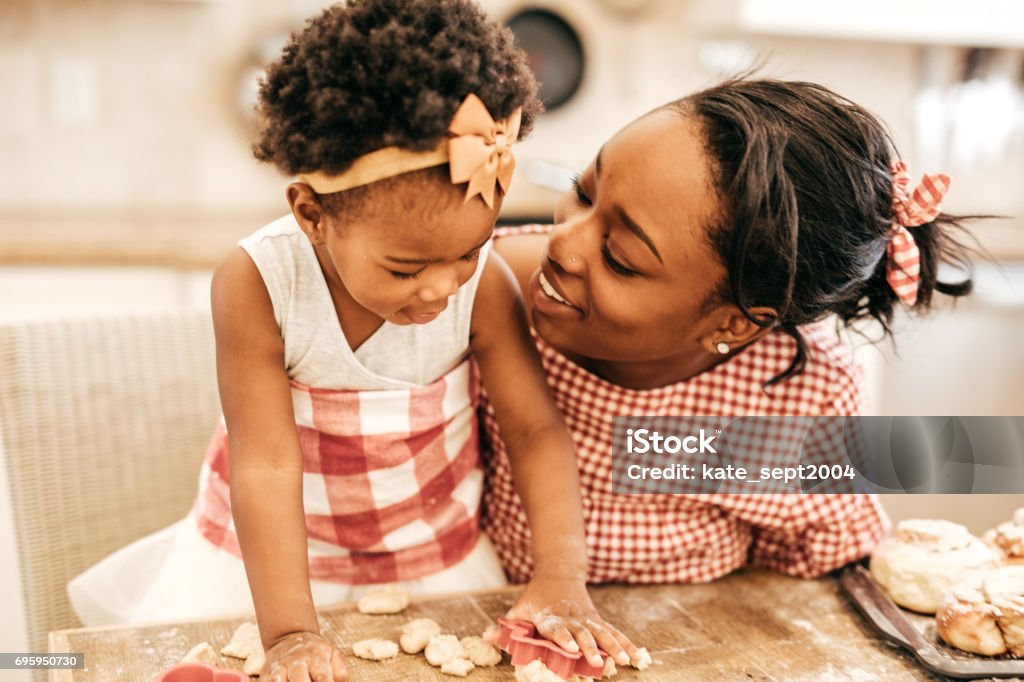 Mom and toddler baking together Family Stock Photo