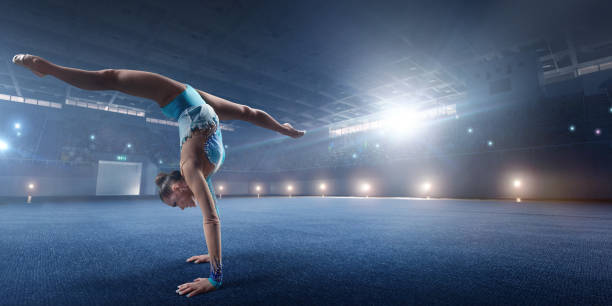 istock A gymnast girl makes a leap on a large professional stage 695950810
