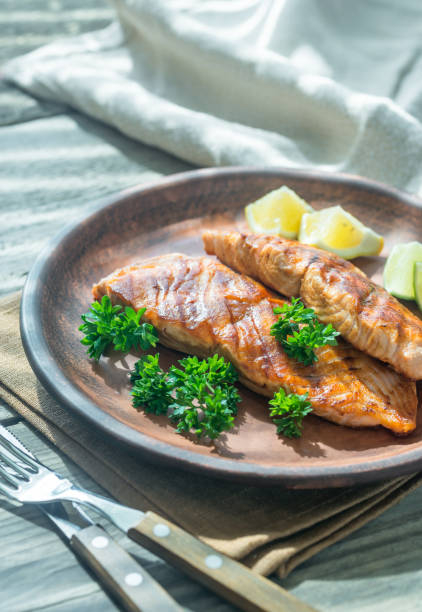 istock Roasted salmon steak with fresh parsley 695951834