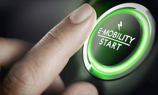 E-Mobility, Green Car Start Button Man pushing green car button. Concept of e-mobility. Composite image between a hand photography and a 3D background. on the move stock pictures, royalty-free photos & images